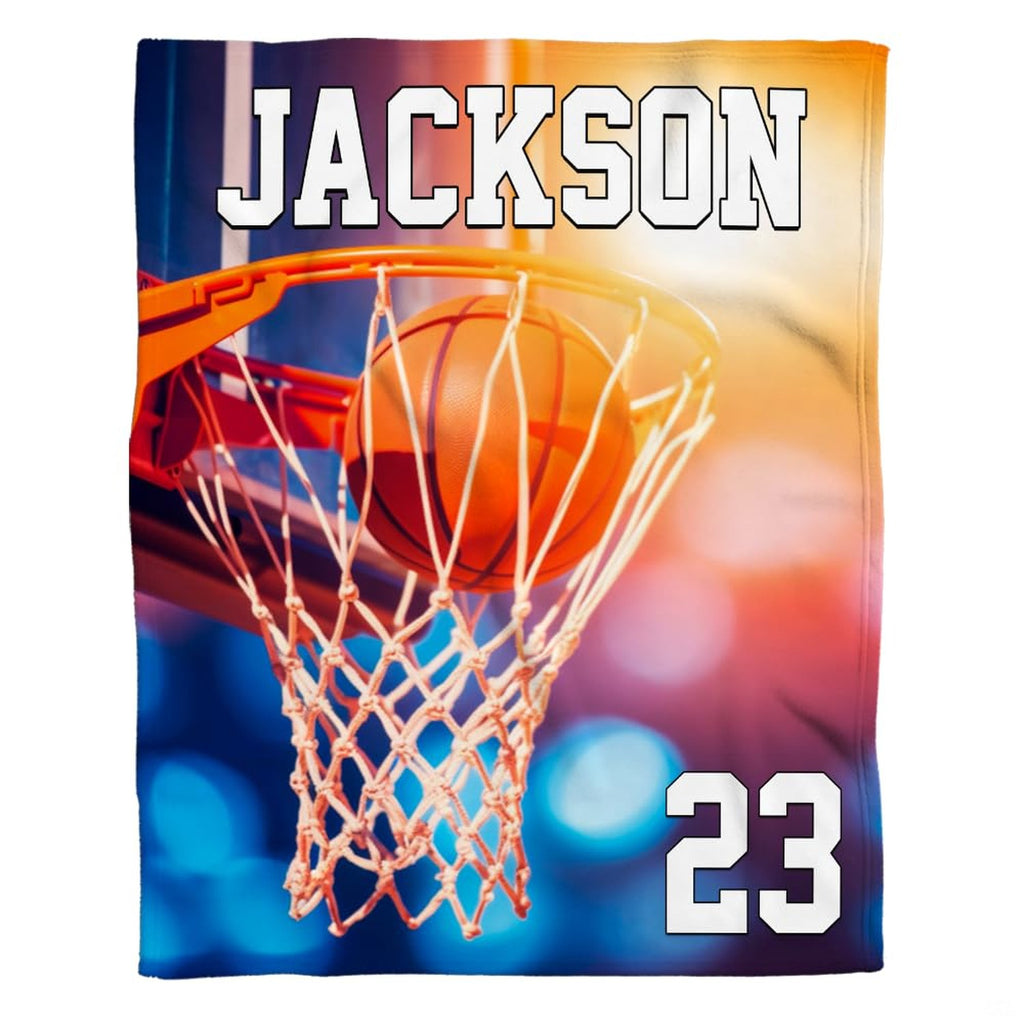 Basketball swishing through hoop and net with stadium lighting, view 1.