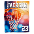 Basketball swishing through hoop and net with stadium lighting, view 1.