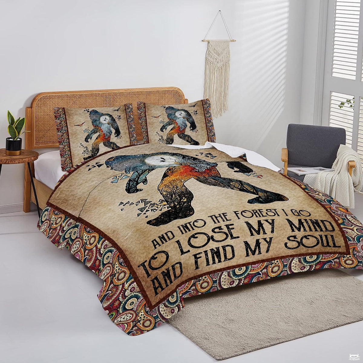 Overhead view of rustic Bigfoot quote bedding arranged neatly across a woodland cabin mattress