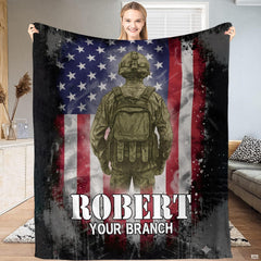 Military soldier and American flag blanket held up indoors.