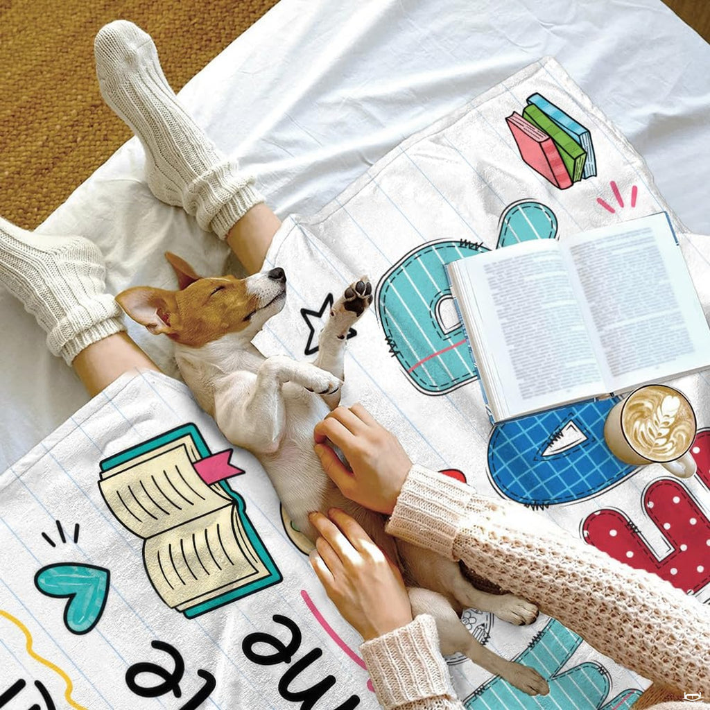 Stylized view of colorful alphabet patchwork print and notebook backdrop on bedding set.