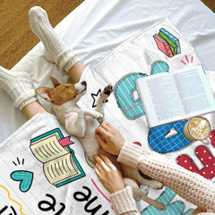 Stylized view of colorful alphabet patchwork print and notebook backdrop on bedding set.