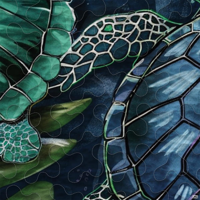 Close-up view of turtle bedding showcasing intricate Polynesian tribal motifs and coral red tones