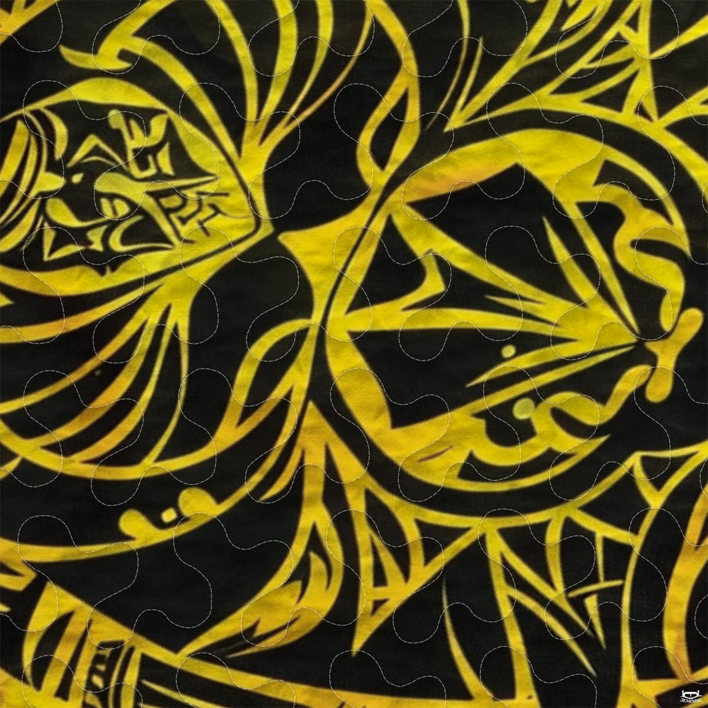 Close-up view of turtle bedding showcasing intricate Polynesian tribal motifs and golden yellow tones