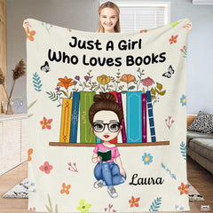 Woman holding bookshelf reader blanket upright in living room displaying full graphic artwork
