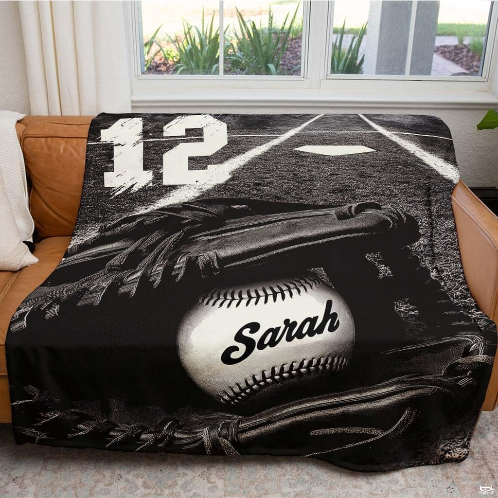 Close view of baseball in mitt and home plate chalk on graphic blanket