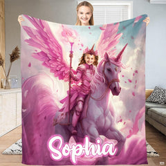 Woman standing and holding up full length pink winged unicorn blanket