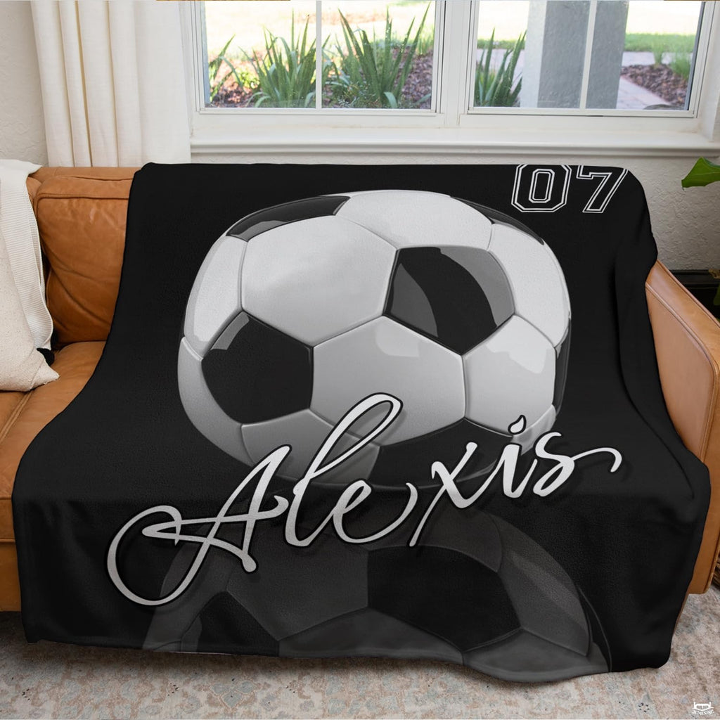 Monochromatic soccer graphic bedding arranged neatly in a bright modern bedroom setting.