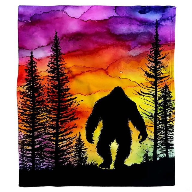 Bigfoot sunset throw blanket view 2 highlighting Sasquatch silhouette, pine trees, and magenta twilight
