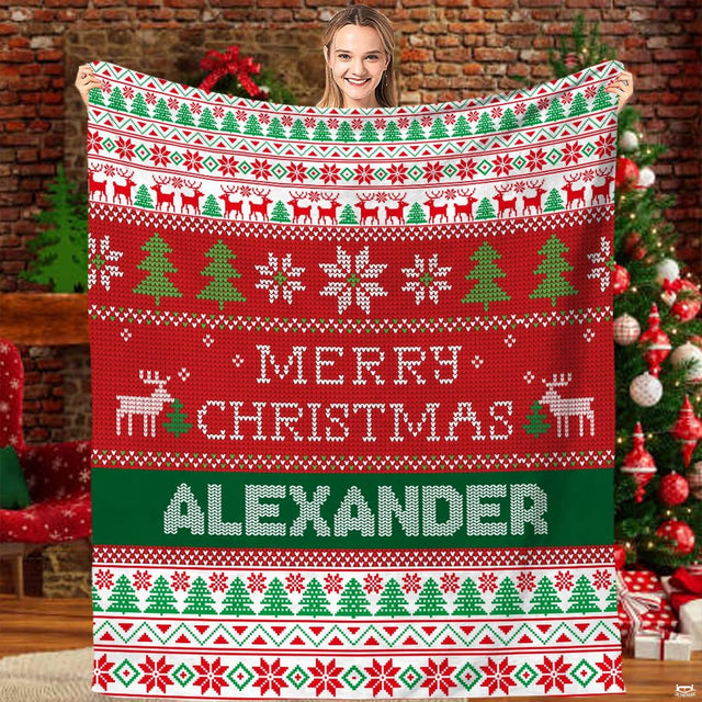 Festive ugly sweater holiday Fair Isle blanket held before Christmas tree