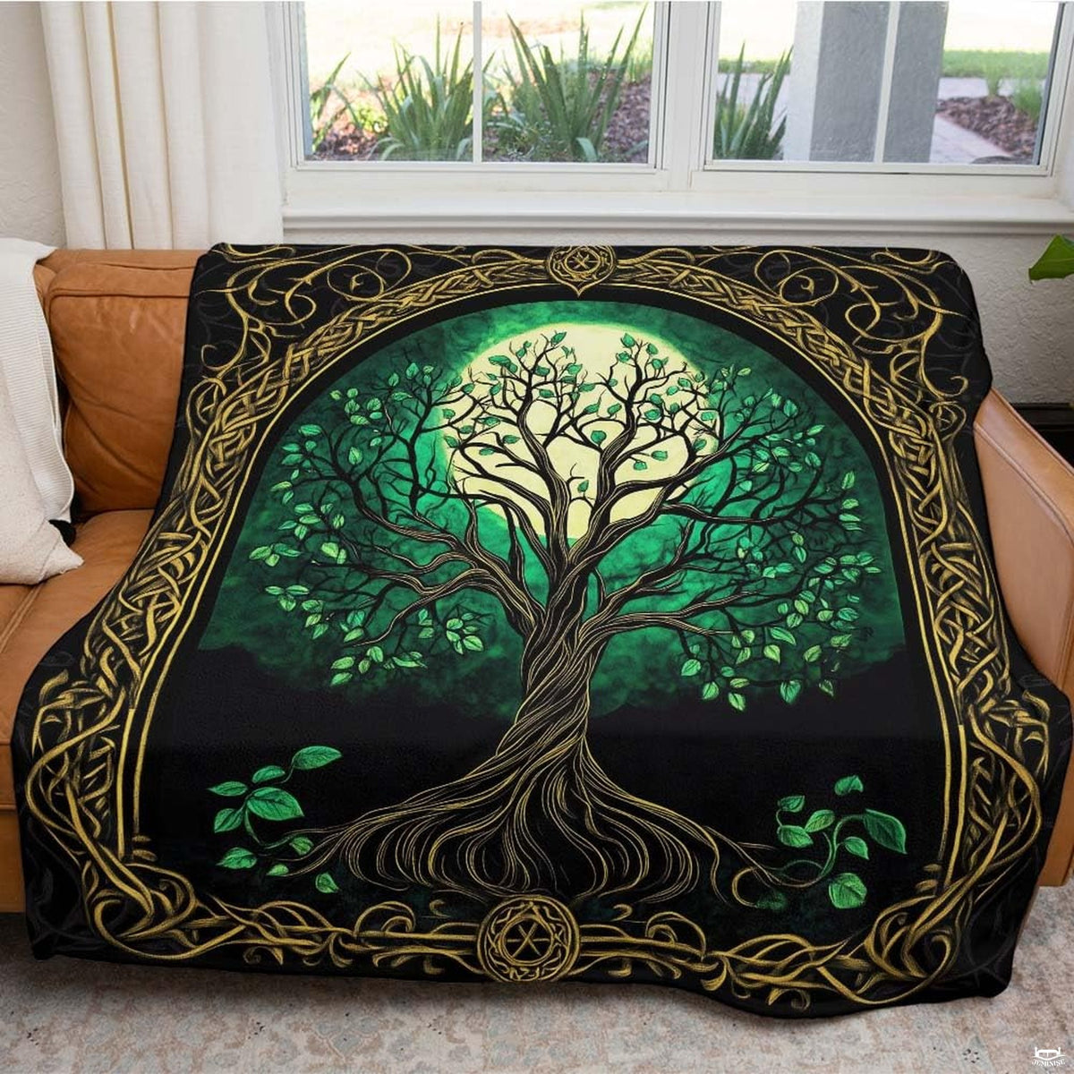 Atmospheric reading corner featuring Celtic gothic arch tree throw blanket draped on armchair