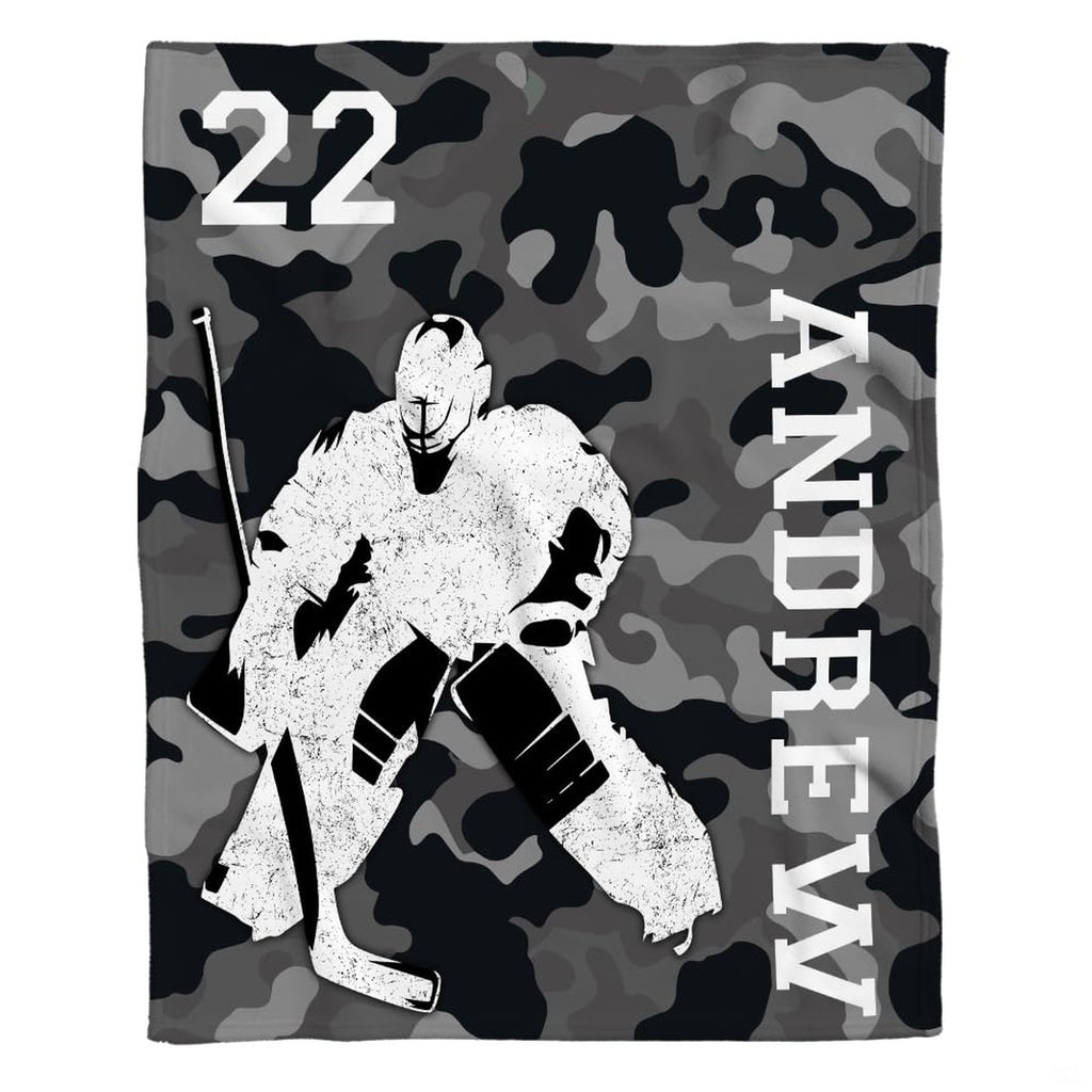 Graphic layout of ice hockey goalie design on grey camouflage ground with vertical block lettering.