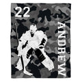 Graphic layout of ice hockey goalie design on grey camouflage ground with vertical block lettering.