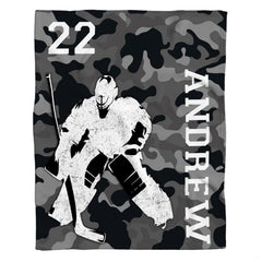 Graphic layout of ice hockey goalie design on grey camouflage ground with vertical block lettering.