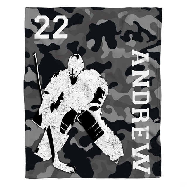 Graphic layout of ice hockey goalie design on grey camouflage ground with vertical block lettering.