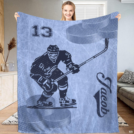 Full view of ice hockey skater gliding across a frosty ice blue background on a sports blanket.