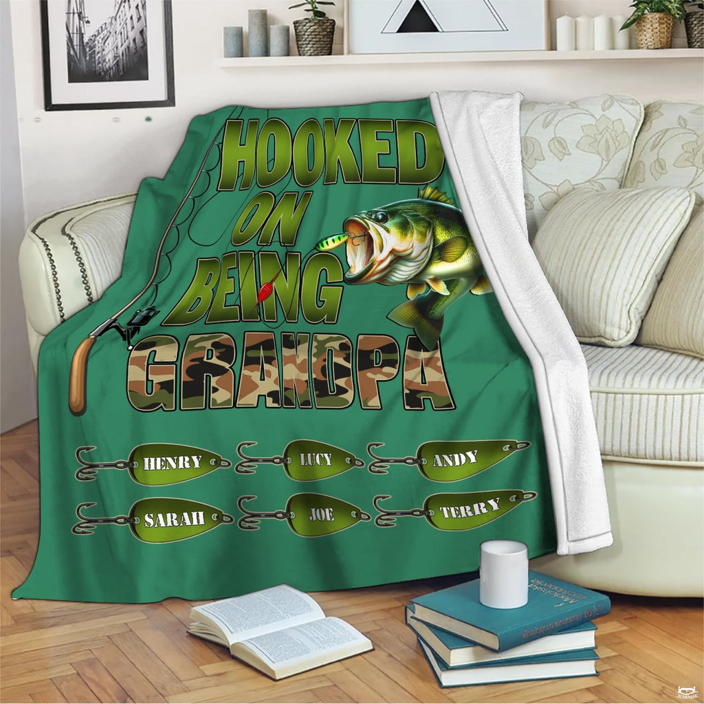 Freshwater angling artwork styled across couch seating alongside books and mug on wooden floor