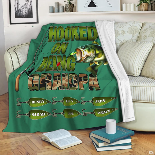 Freshwater angling artwork styled across couch seating alongside books and mug on wooden floor