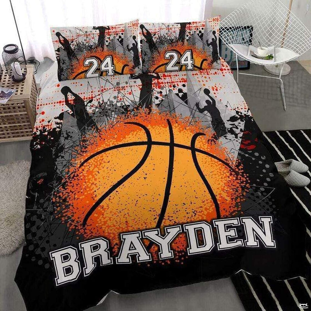 Orange splatter basketball silhouette sports bedding set featuring a textured basketball and action player silhouettes