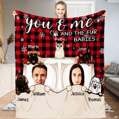 Illustrated couple and cartoon pets on red and black buffalo plaid background, view 1.
