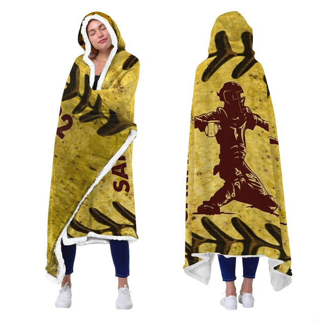 Fastpitch catcher sports graphic blanket worn as hooded wrap