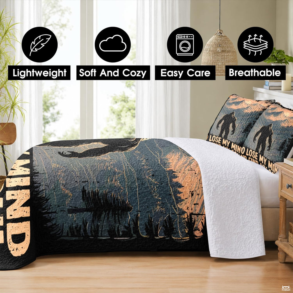 Rustic cabin bedroom decor with Bigfoot wilderness landscape artwork on bedding.