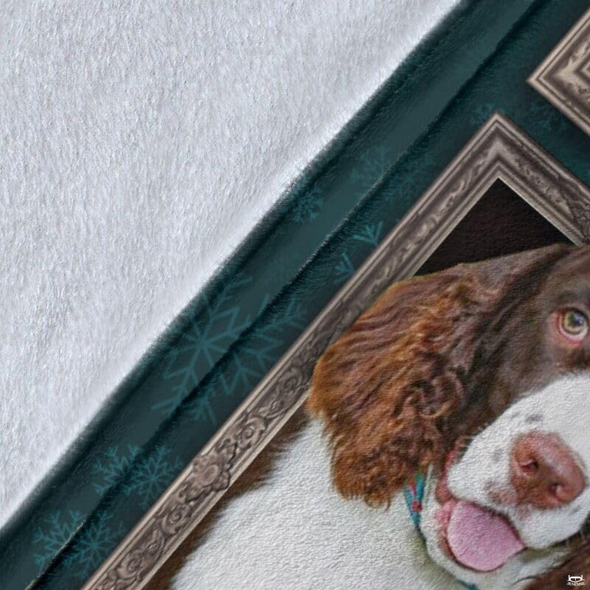 Close-up detail shot of the English Springer Spaniel blanket showing edge detail and teal snowflake art.