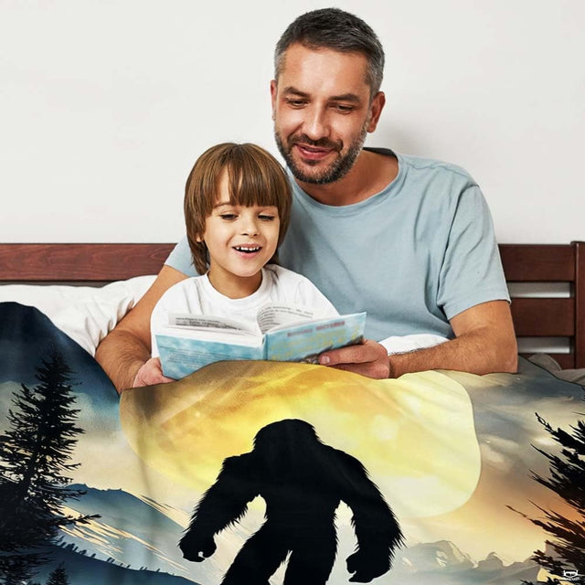 Close-up view of the glowing golden moon and Bigfoot silhouette illustration.