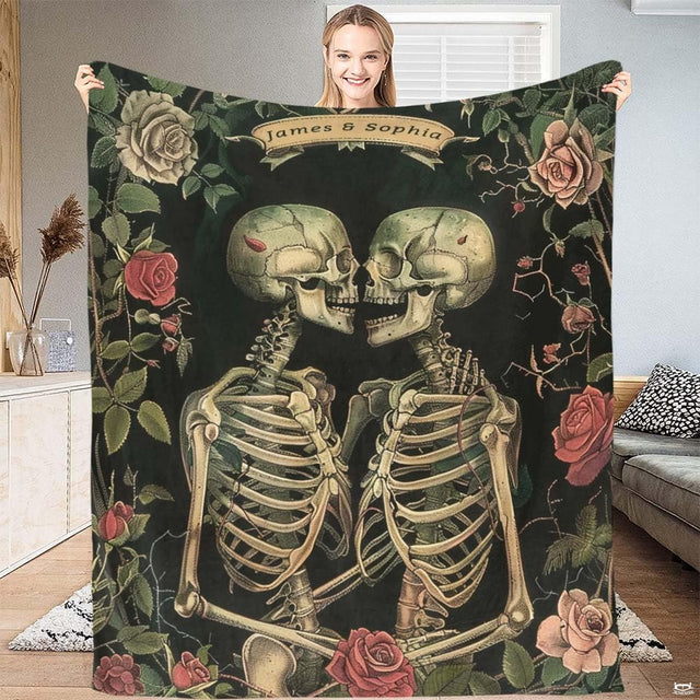 Gothic skeleton lovers botanical throw blanket featuring two embracing skeletons and vintage pink roses