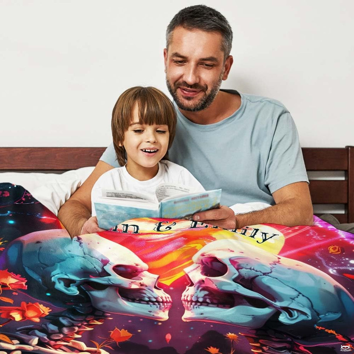 Close-up perspective of skeleton figures and red roses on throw blanket
