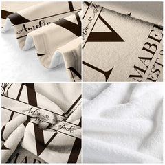 Lifestyle display of split letter crest throw blanket styled on a master bed