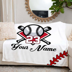 Person holding open the baseball blanket showing the large centered sports graphic in a room.