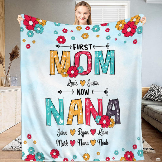 First Mom Now Nana throw blanket featuring retro daisy flowers and patterned block typography on sky blue