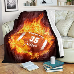 Flaming sports football graphic blanket styled across bedroom bed