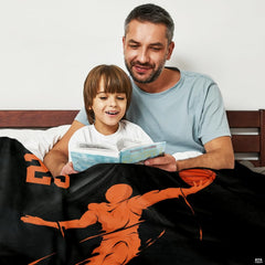 Close-up view of stylized speed streaks and slam dunk player silhouette graphics on black bedding.