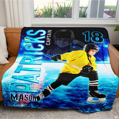 Angle perspective of youth hockey throw blanket draped over sports fan reading armchair
