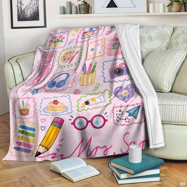 Teacher doodle throw blanket displayed over a neutral living room sofa