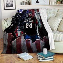Living room sofa setting displaying patriotic lacrosse player throw blanket draped over furniture.