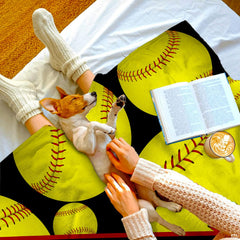Living room staging displaying diagonal sash softball throw blanket styled across a sofa.