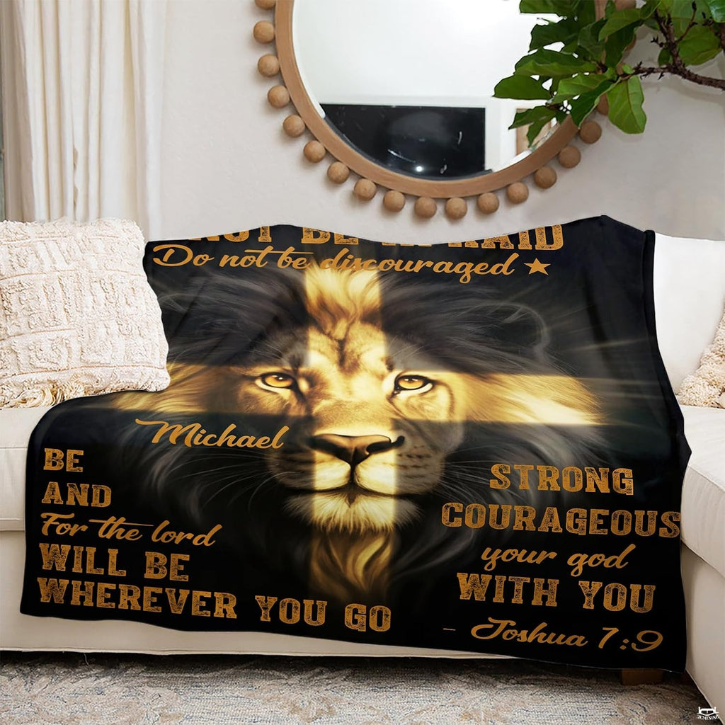 Devotional lion throw blanket arranged over indoor seating beneath an ornamental wall mirror.