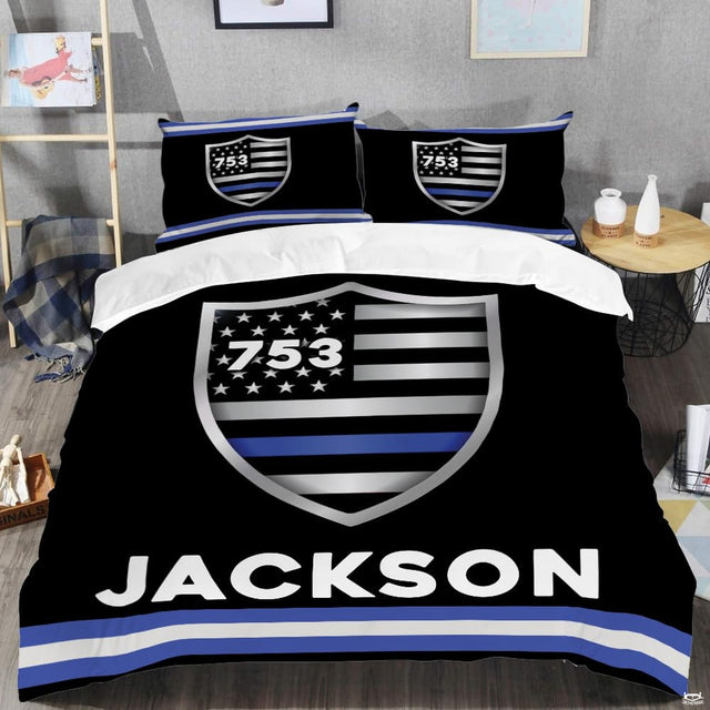 Minimal flag shield artwork in black, silver, white, and blue with crisp border stripes