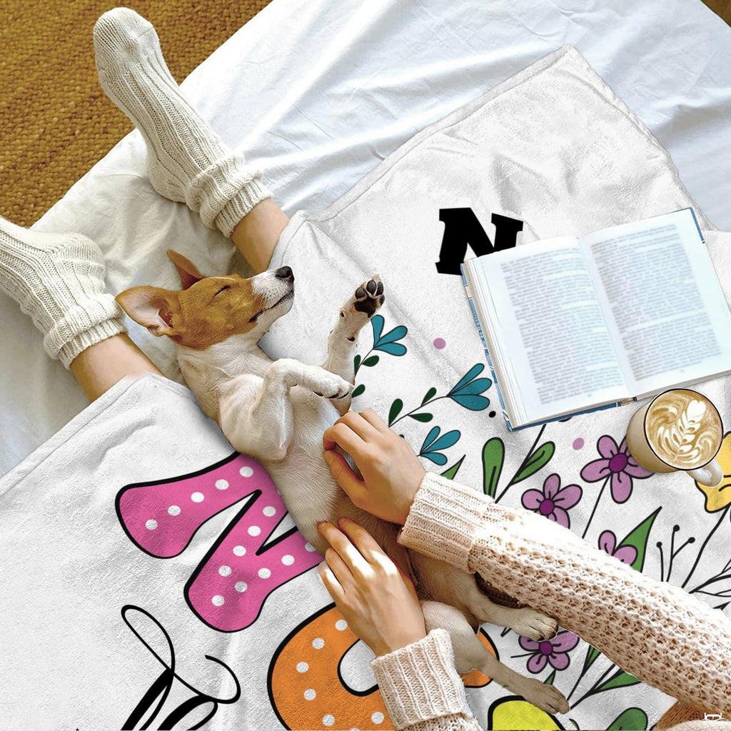 Detailed illustration of playful pastel lettering and botanical sprigs on floral bedding.