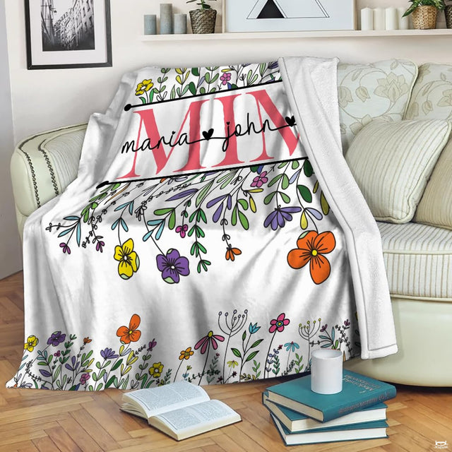 Wildflower garden floral throw blanket view 2 highlighting colorful flower petals, foliage, and room styling