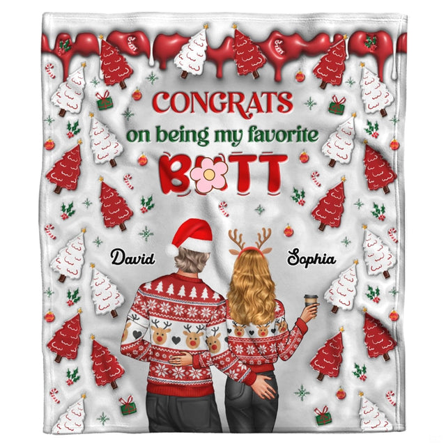 Holiday couple in reindeer sweaters with frosted Christmas tree cookies and holiday greeting, view 2.