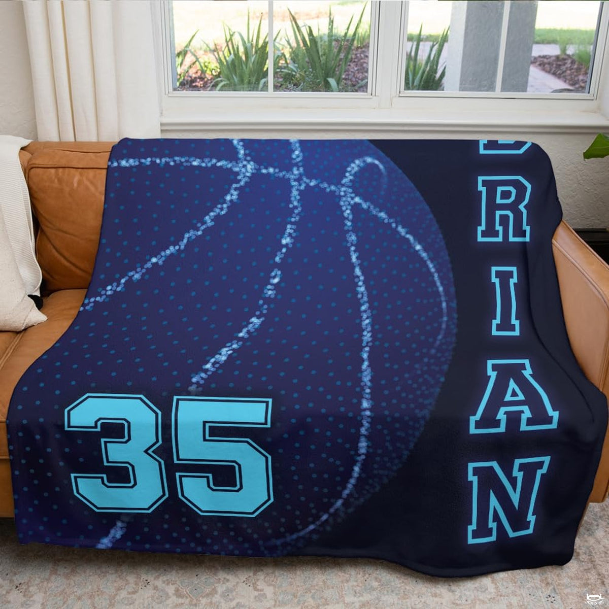 Stylized glowing basketball artwork with collegiate varsity details featured on bedroom decor bedding.