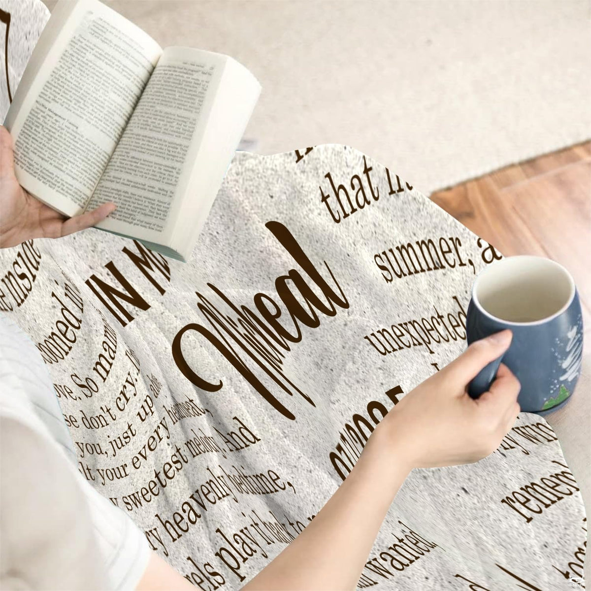 Close view of individual holding mug with memorial blanket draped over knees.
