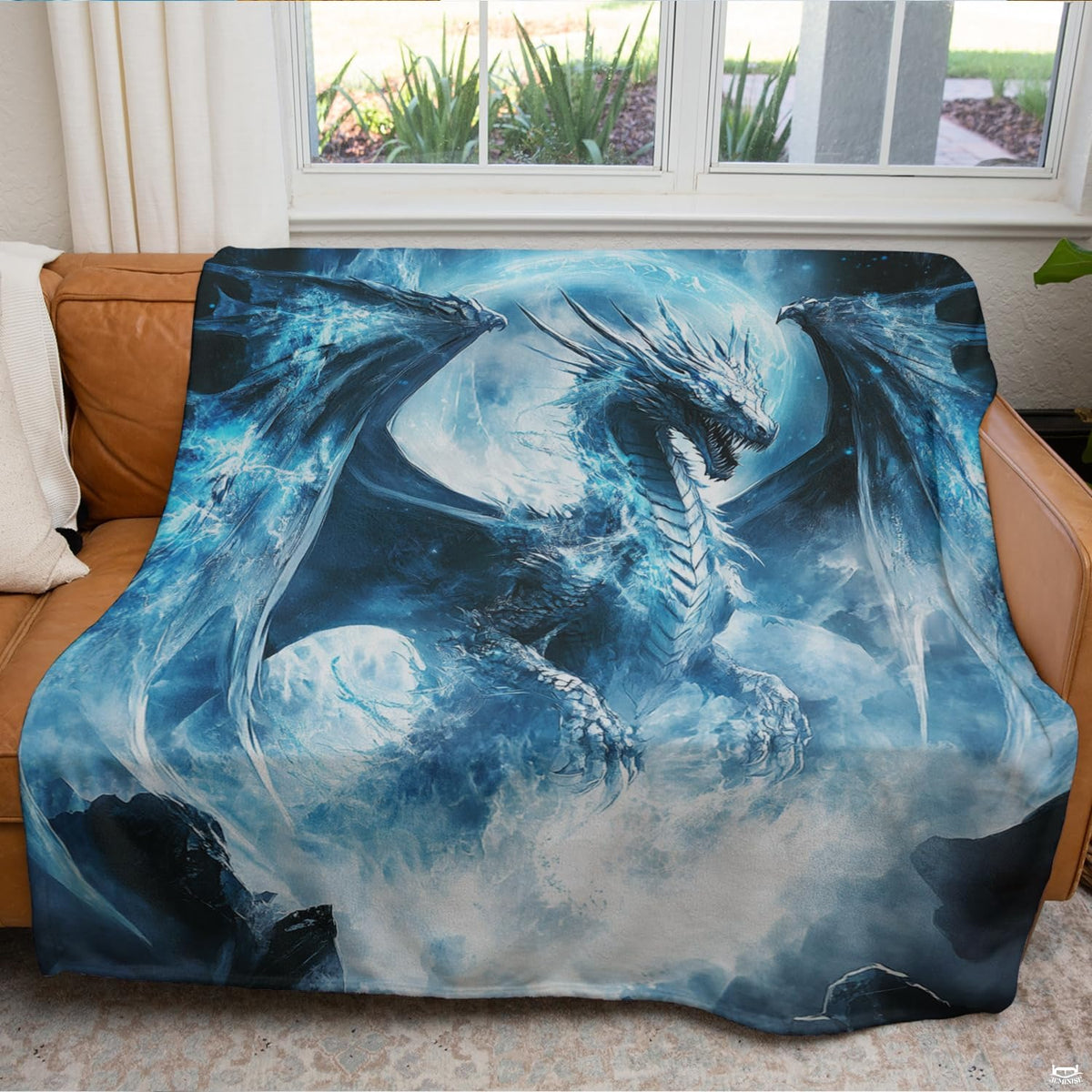 Glacial ice dragon throw blanket draped across a modern living room couch