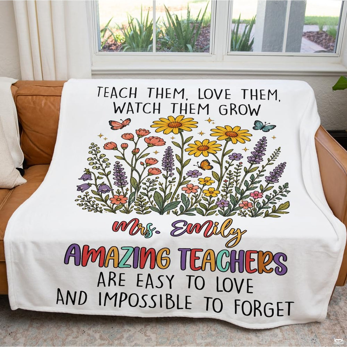 Full overhead display of teacher appreciation wildflower throw blanket on light wooden floor