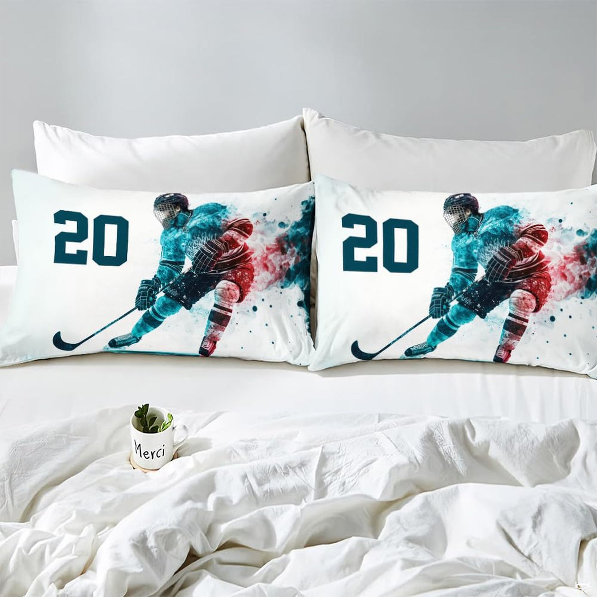 Side angle view of athletic winter sports bedding showing ocean teal and berry coral tones on mattress