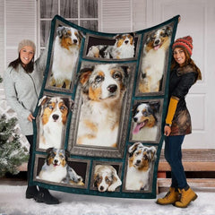 Two models displaying the Australian Shepherd blanket outside a snowy winter home entrance.
